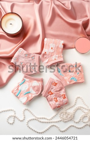 Pastel composition with pink socks on white background