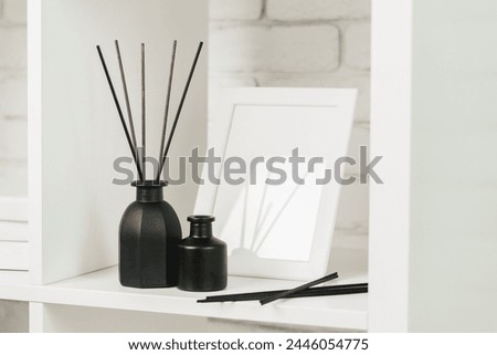 Elegant Black Reed Diffuser on White Shelf in Minimalist Home Decor Setting
