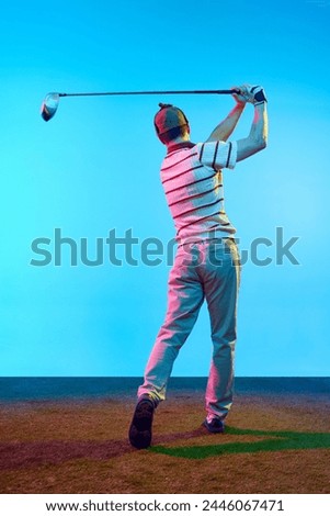 Rear view portrait of golfer in retro outfit with golf club taking shot in neon light against gradient blue background. Concept of professional sport, luxury games, active lifestyle, action. Ad