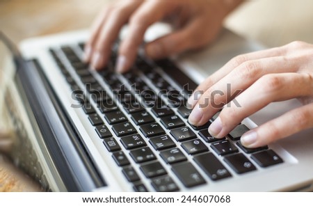 Female fingers on the keyboard close-up. Royalty-Free Stock Photo #244607068