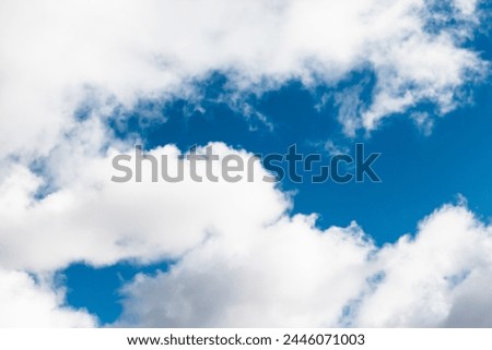 Blue sky background on a cloudy summer day Royalty-Free Stock Photo #2446071003