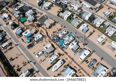 Aerial photo of the town of Benidorm in Spain showing a drone view of a camp site with many motorhomes and caravans on the camping site on a sunny day in the summer time
