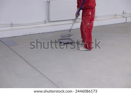 Expert Concrete Painting: Construction Worker Applying Durable Epoxy Coating 