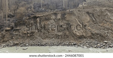 The picture is showing a road river side is sliding due to seepage of water and causing distruction 