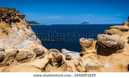 Peculiar geological landscape of mushroom-shaped rocks near the Shen'ao Fishing Harbor in New Taipei City of Taiwan, consists of abundant competent iron-rich nodules stand atop sandstone layers. Royalty-Free Stock Photo #2446091839