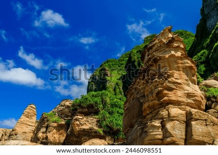 The Nanya Peculiar Rocks, where a series of isolated sandstone pillars formed by fracturing along rock joints stand on the coast of Ruifang District of New Taipei City, northeastern Taiwan. Royalty-Free Stock Photo #2446098551