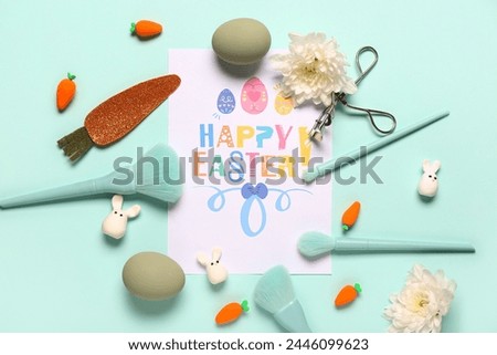 Composition with greeting card, makeup accessories and Easter decor on turquoise background