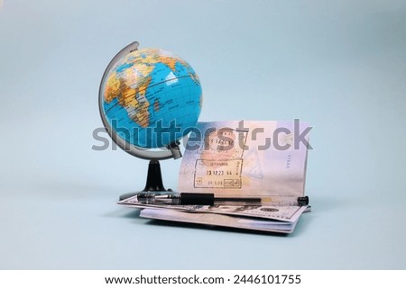 World globe, pen and book of passport with copy space. Travel and vacation concept