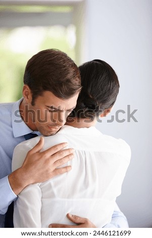 Businessman hug woman for comfort, support and relief at company office. Sad employee and manager help with grief, anxiety and work stress for depression or mental health at professional workplace Royalty-Free Stock Photo #2446121699
