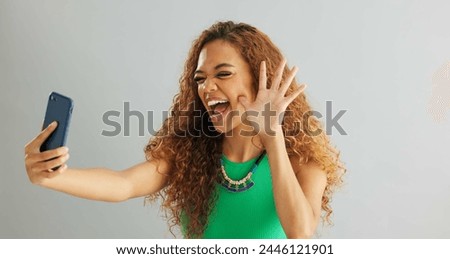 Happy woman, peace sign and selfie with kiss for social media, vlog or memory on a gray studio background. Female person with smile on mobile smartphone for photography or picture on mockup space