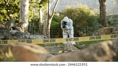 Forensic, photographer and evidence at crime scene for investigation in forest with police tape and safety hazmat..Csi quarantine, expert investigator and pictures for observation and case research