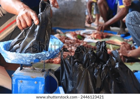 membagikan daging kurban pada hari raya idul adha di madiun Royalty-Free Stock Photo #2446123421