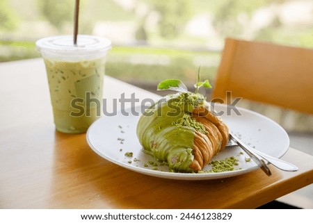Matcha green tea with croissant on the wooden table at Choui Fong tea plantation in Chiang Rai province, Thailand Royalty-Free Stock Photo #2446123829