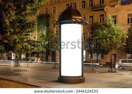 Mockup Of Round Lightbox Display In A City Square At Night. Retro Style Billboard Stand