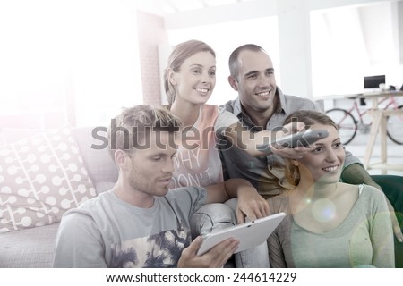 Roommates in apartment watching tv Royalty-Free Stock Photo #244614229