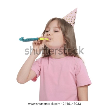 Cute little girl in party hat with blower on white background