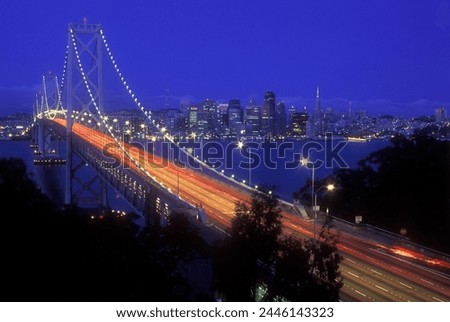 Oakland Bay Bridge illuminated at dusk with traffic streaks, San Francisco, California, United States of America, North America