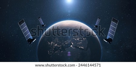 Satellites in orbit of planet Earth with the lights of the night cities of Europe. satellite internet connection.