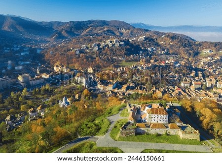 Aerial drone view of the city of Brasov in Romania with historic houses at the foot of the Tampa hill in Transylvania, in the autumn season
