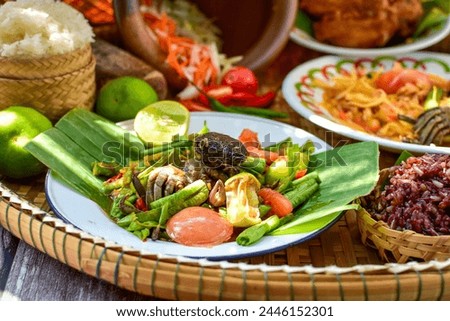 Sticky rice, papaya salad, Som Tam , thai food, isan food,Thai isan kitchen,Long bean salad,Long bean thai spicy salad Royalty-Free Stock Photo #2446152301