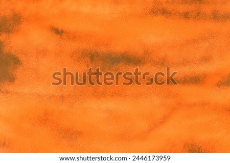 Bright orange paint brush strokes abstract design pattern texture surface background backdrop.