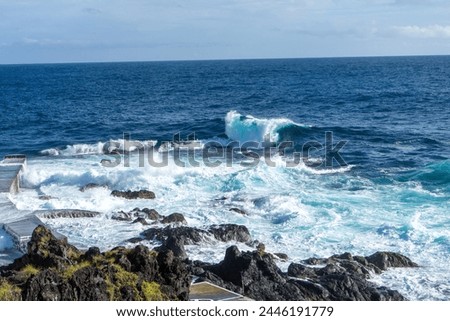 Powerful waves crash along the shoreline of Cinco Ribeiras, a scenic bathing area on Terceira Island, Azores. Royalty-Free Stock Photo #2446191779