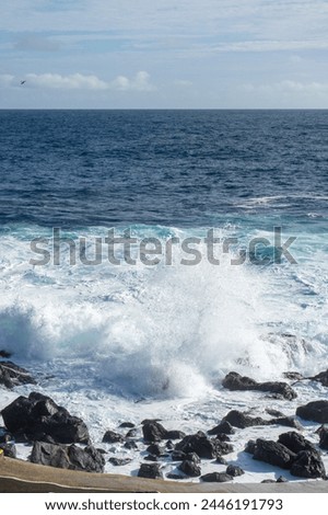 Powerful waves crash along the shoreline of Cinco Ribeiras, a scenic bathing area on Terceira Island, Azores. Royalty-Free Stock Photo #2446191793