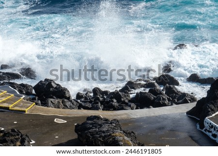 Powerful waves crash along the shoreline of Cinco Ribeiras, a scenic bathing area on Terceira Island, Azores. Royalty-Free Stock Photo #2446191805