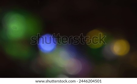 Defocused neon light. Overlay of light highlights. Colorful bokeh. Futuristic LED lighting. Blur of colors on dark abstract background