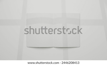 a book opened on a white surface with a shadow