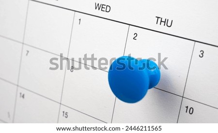 Blue color pin thumbtack a date 2nd calendar or planner. 
Final Day takes place deadline Thursday 2 day.   (selective focus) Royalty-Free Stock Photo #2446211565
