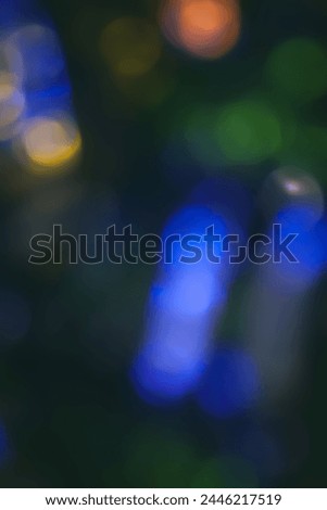 Defocused neon light. Overlaying highlights. Colorful bokeh. Futuristic LED illumination. Blur of colors on dark abstract background