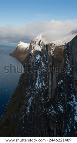 Aerial drone photo of snowy mountain hike near Segla in Senja, Norway.  Snowcapped mountains in the Arctic Circle of Northern Norway.  Famous hike on Senja island.