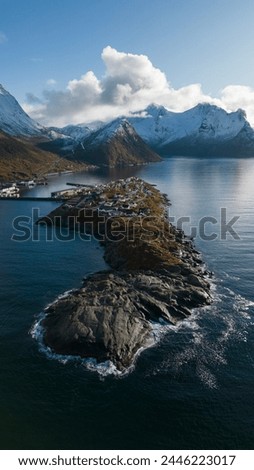 Aerial drone photo of the small island fishing town of Husøy on Senja, Norway.  A fishing village located in the Arctic Circle of Northern Norway.  Shot with a DJI Air 2s