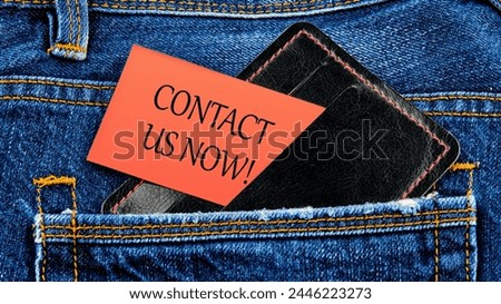 CONTACT US NOW word inscription on business cards from a purse from a jeans pocket