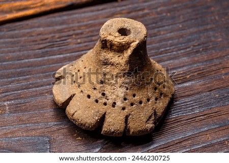 The Dyakov type weight is an archaeological clay artifact from the Early Iron Age. Central Russia Royalty-Free Stock Photo #2446230725