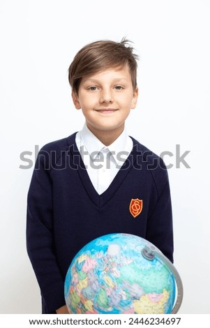 Schoolboy holding globe. Back to school concept. High quality photo	