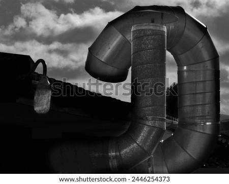 View of steel pipes leading from a caravan park laundrette. Royalty-Free Stock Photo #2446254373