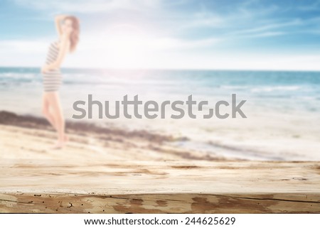 wooden top of free space for you and beach with woman 