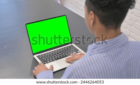 African Woman Using Laptop with Chroma Key Screen