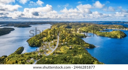 Small Town, Coast on East Coast of Atlantic Ocean. Aerial Nature Background. Sunny Blue Sky. Newfoundland, Canada. Royalty-Free Stock Photo #2446281877