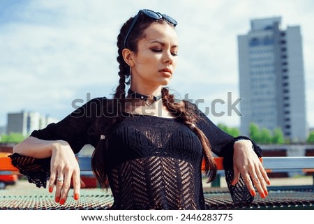 Summer sunny lifestyle fashion portrait of young stylish hipster woman walking on the street