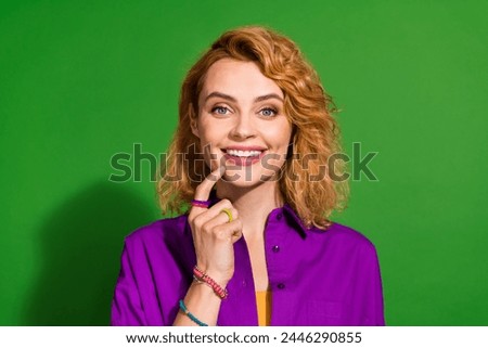 Photo portrait of attractive young girl toothy smile thoughtful dressed stylish violet garment isolated on green color background
