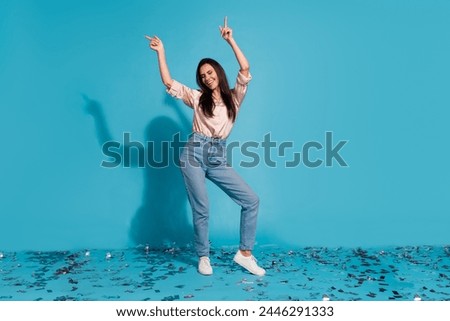 Full length photo of positive sweet lady dressed beige shirt pointing fingers dancing discotheque isolated blue color background