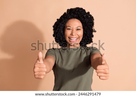 Portrait of optimistic person with perming coiffure wear khaki t-shirt show you thumbs up nice job isolated on pastel color background
