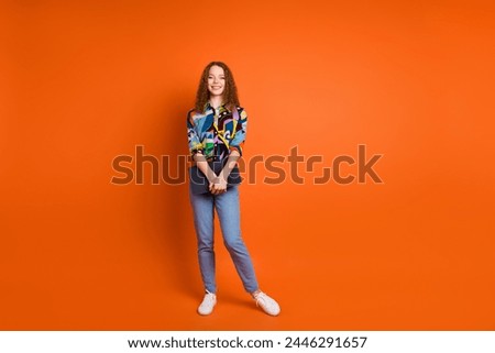 Photo of pretty adorable nice girl wear stylish print clothes hold netbook isolated on vivid orange color background