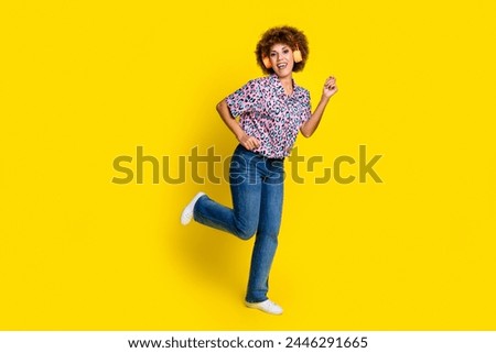 Full length photo of charming carefree lady dressed leopard print shirt earphones dancing empty space isolated yellow color background