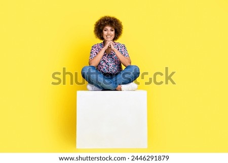 Full length photo of shiny cheerful lady dressed print shirt sitting platform arms chin empty space isolated yellow color background Royalty-Free Stock Photo #2446291879