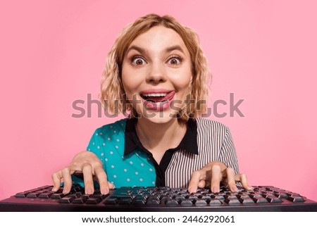 Photo portrait of pretty young girl look excited web camera type keyboard wear trendy striped cyan outfit isolated on pink color background