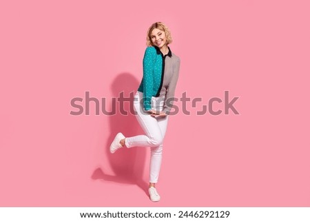 Full size photo of pretty young girl girlish posing model wear trendy striped cyan outfit isolated on pink color background